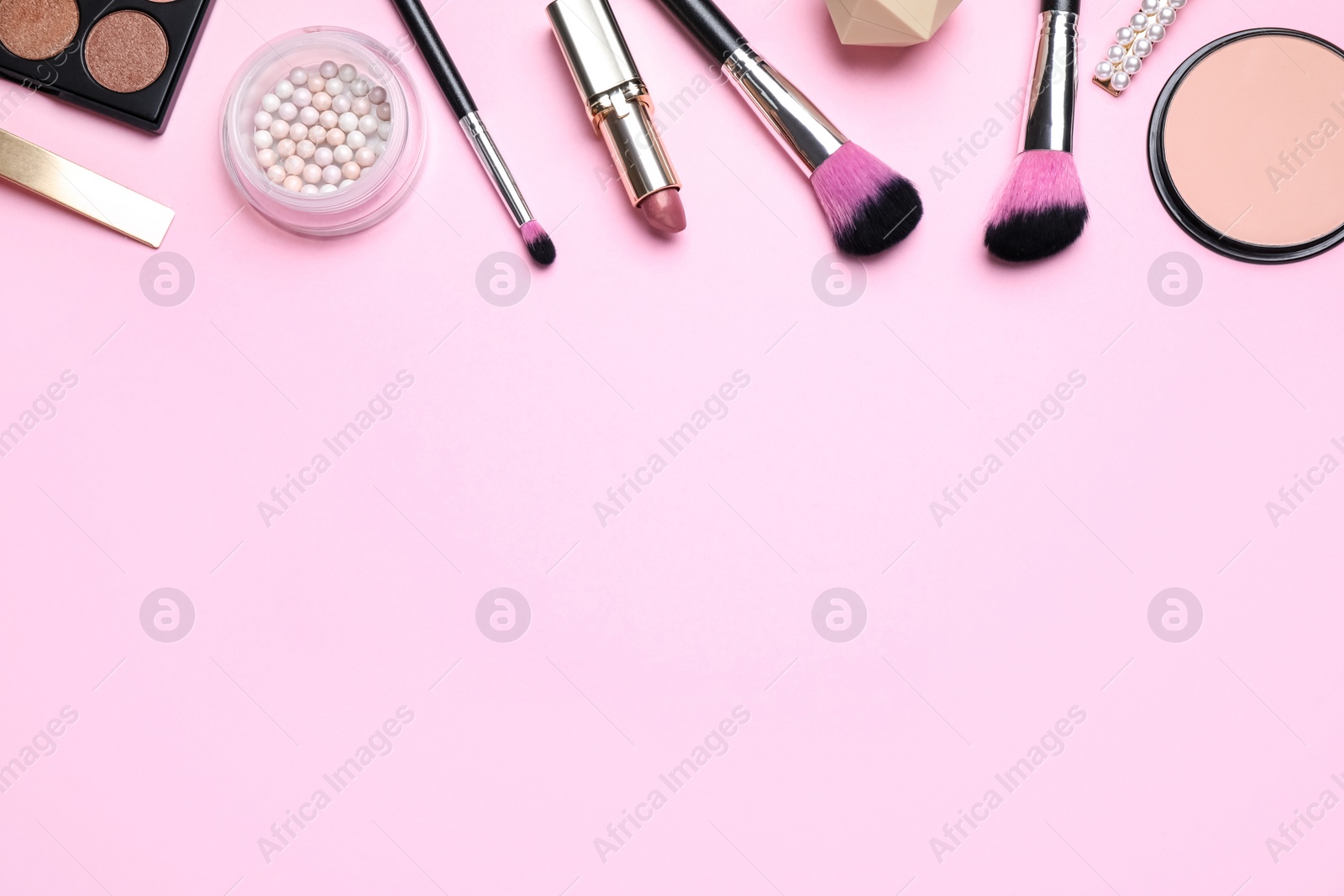 Photo of Makeup brushes and cosmetic products on pink background, flat lay. Space for text