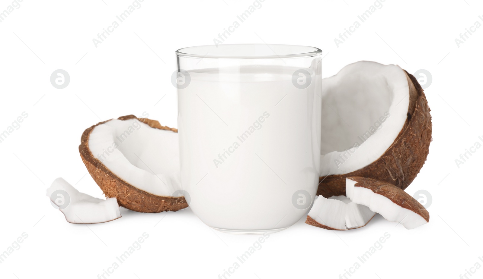 Photo of Glass of delicious vegan milk and coconut pieces on white background