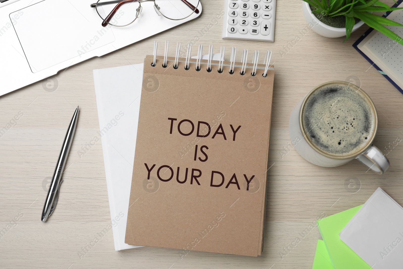 Image of Phrase Today is Your Day in notebook, office stationery and cup of coffee on wooden desk, flat lay