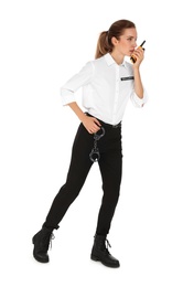 Female security guard in uniform using portable radio transmitter on white background