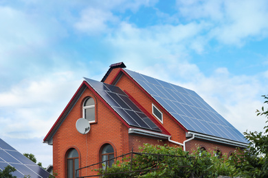 House with installed solar panels on roof