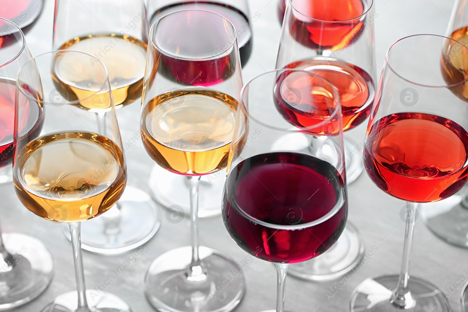 Photo of Group of glasses with different wines on light table