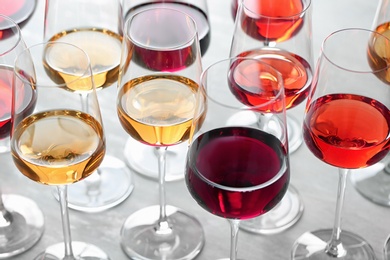 Photo of Group of glasses with different wines on light table