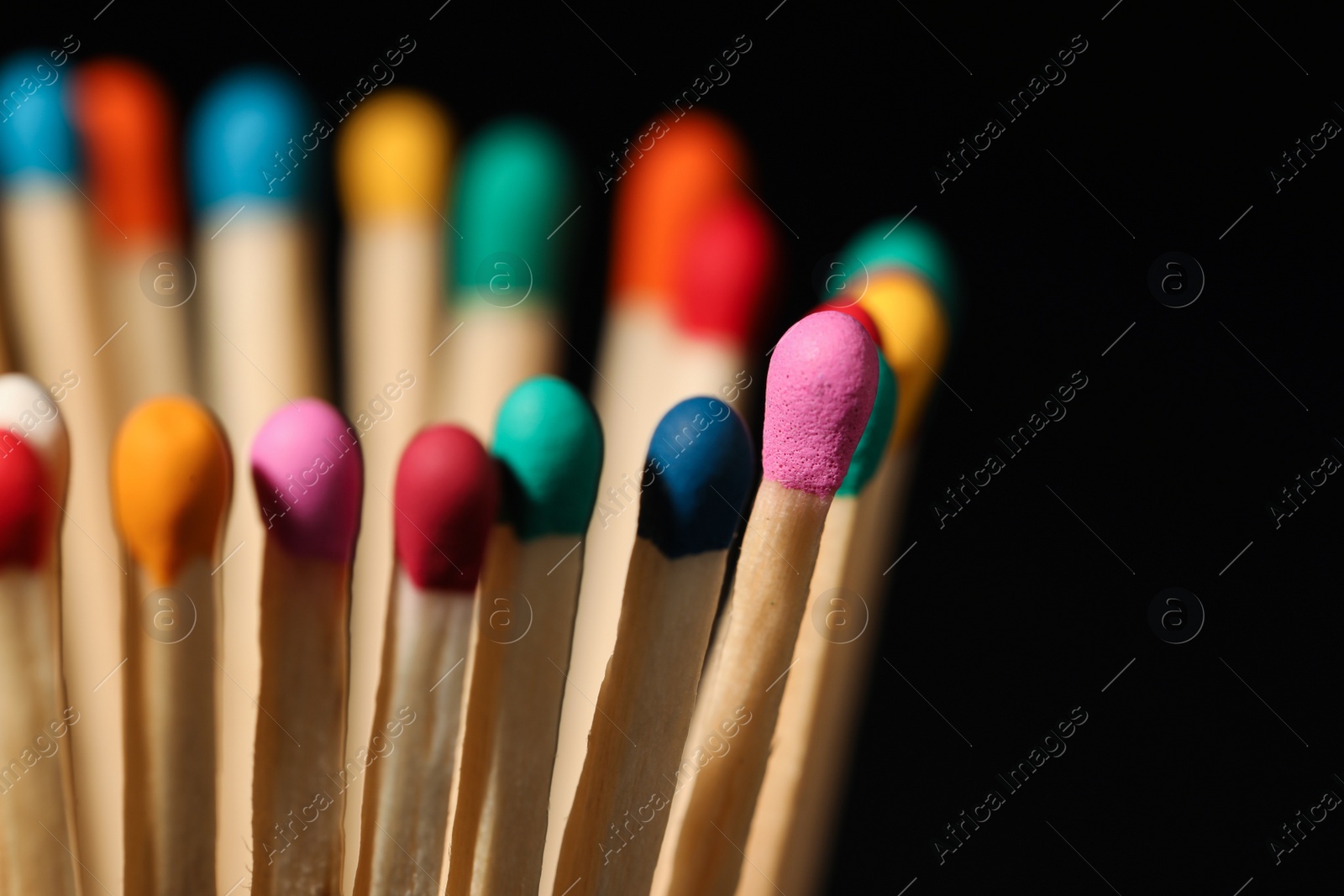 Photo of Matches with colorful heads on black background, closeup. Space for text