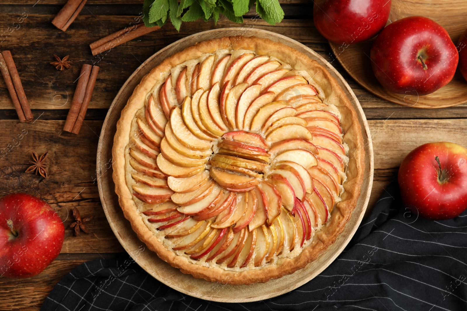 Photo of Flat lay composition with delicious homemade apple tart on wooden table
