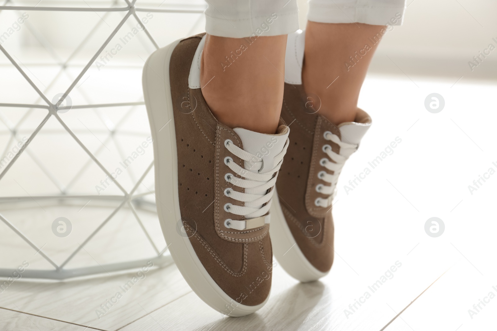 Photo of Woman wearing comfortable stylish shoes indoors, closeup