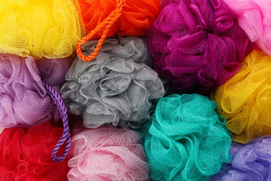 Photo of Many colorful shower puffs as background, closeup