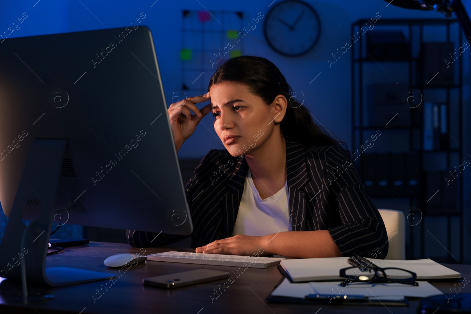 Photo of Tired businesswoman working at night in office