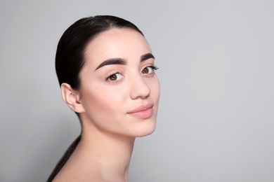 Photo of Beautiful woman with perfect eyebrows on light background