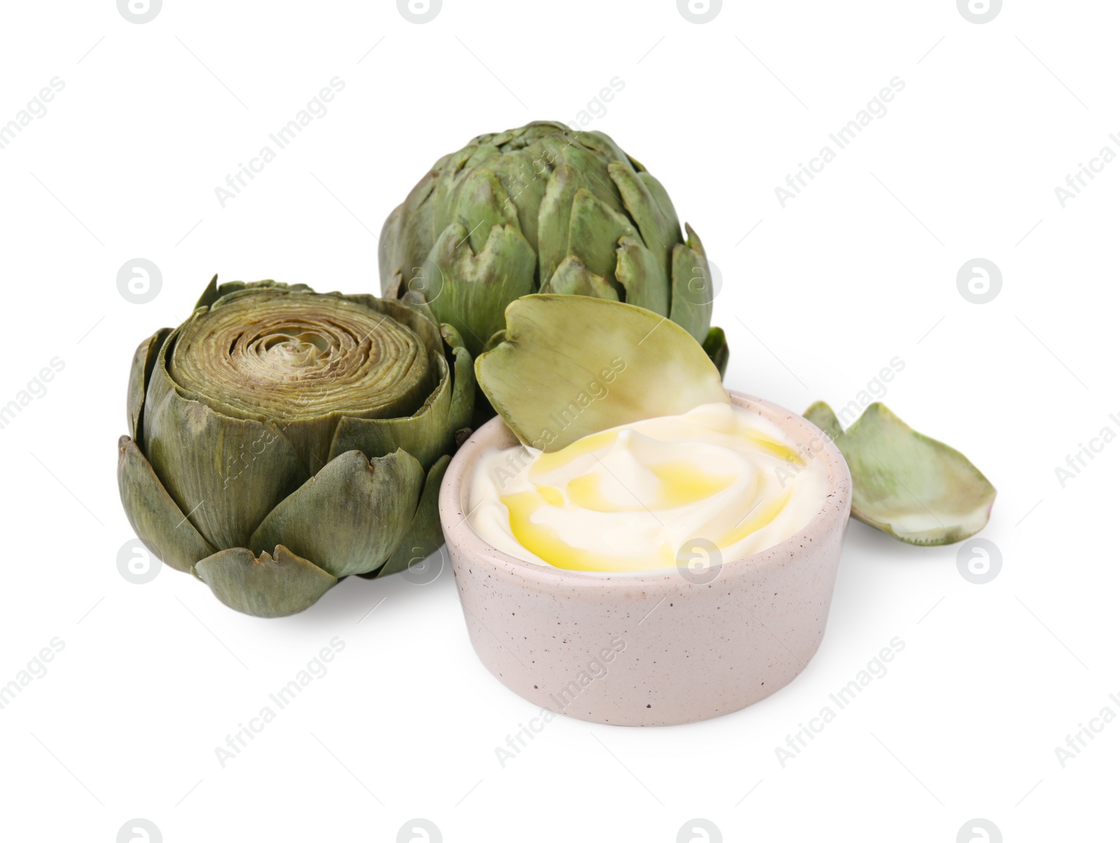 Photo of Delicious cooked artichokes with tasty sauce isolated on white