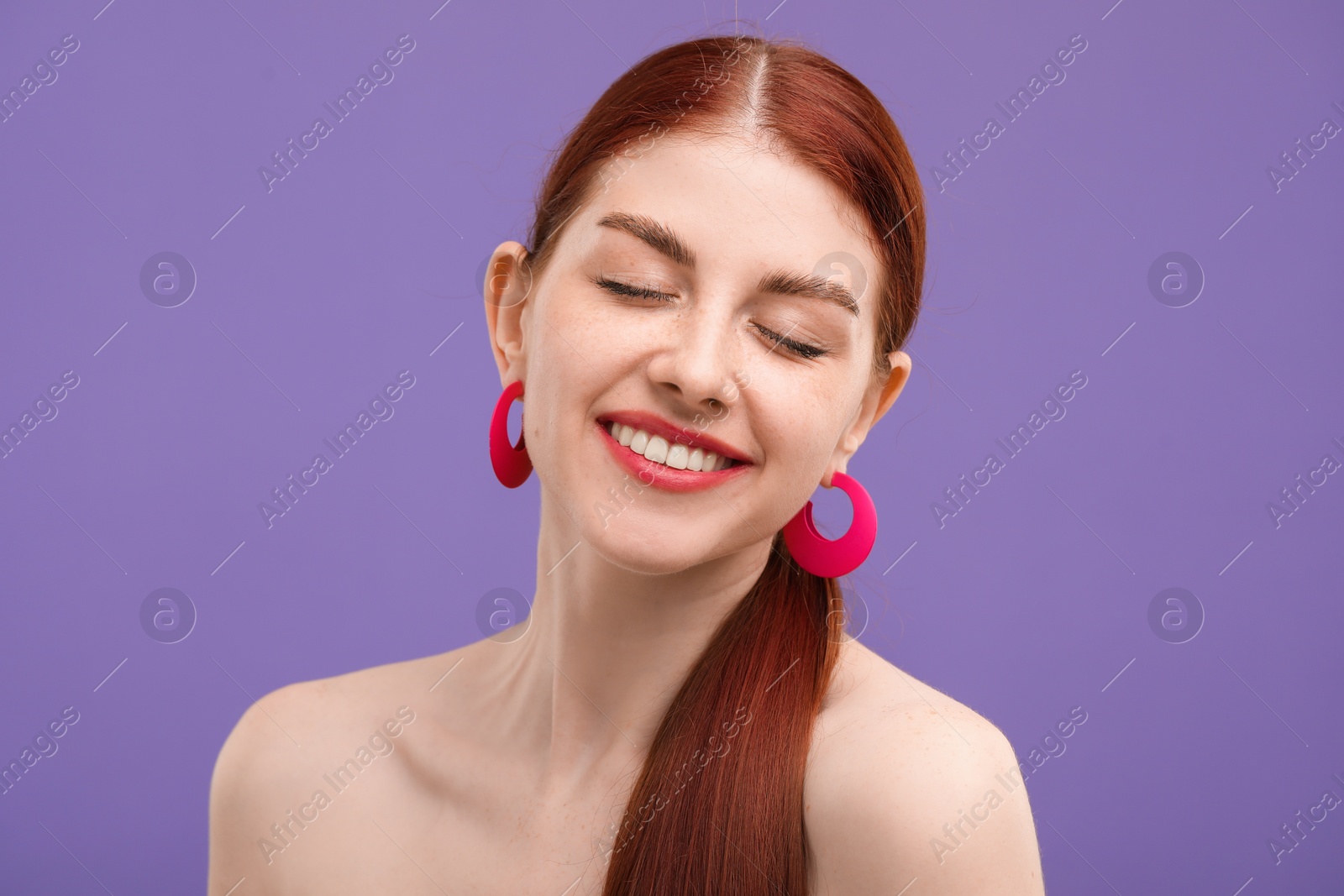 Photo of Portrait of smiling woman on purple background