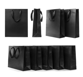 Set with black paper shopping bags on white background
