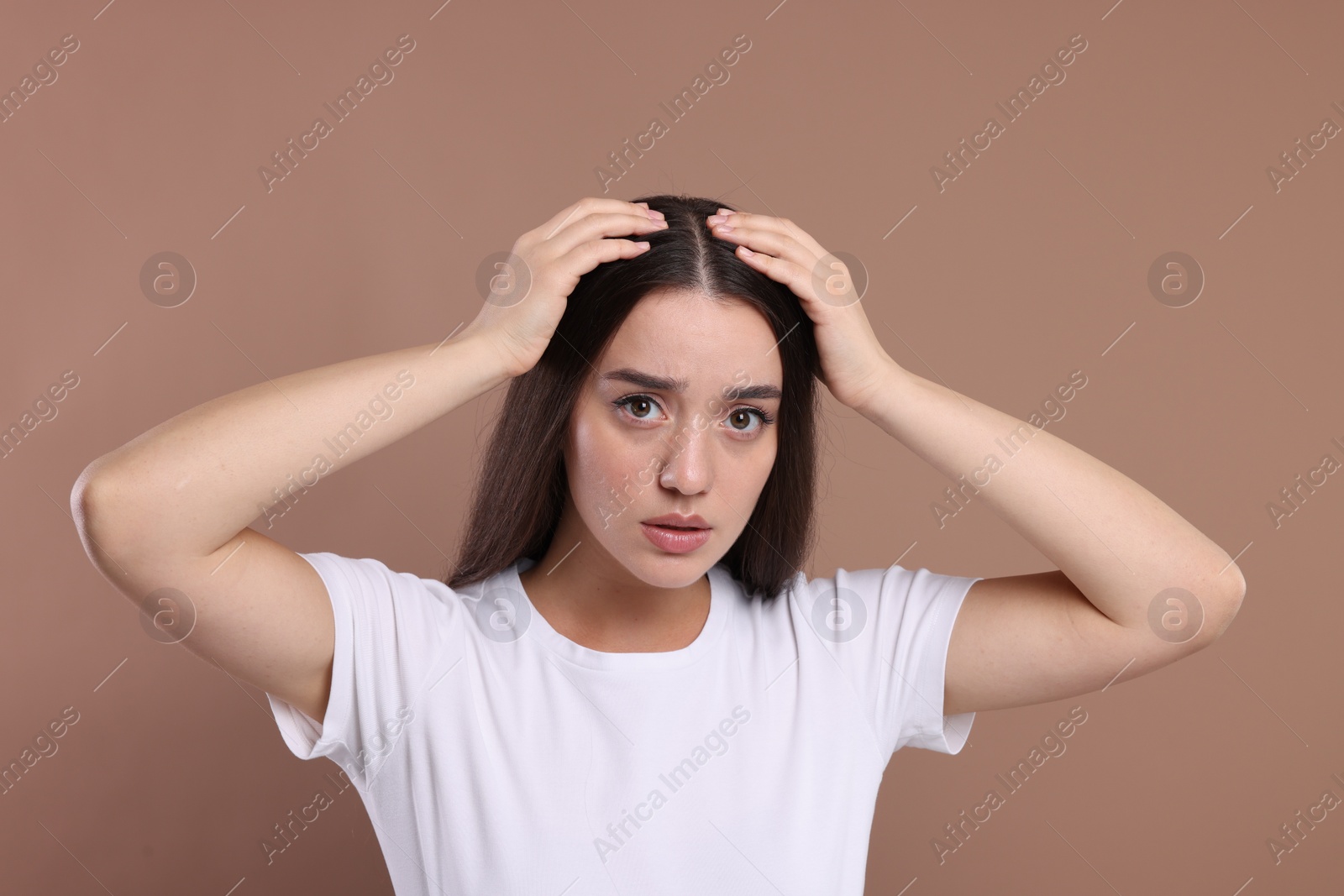 Photo of Emotional woman with healthy hair on beige background