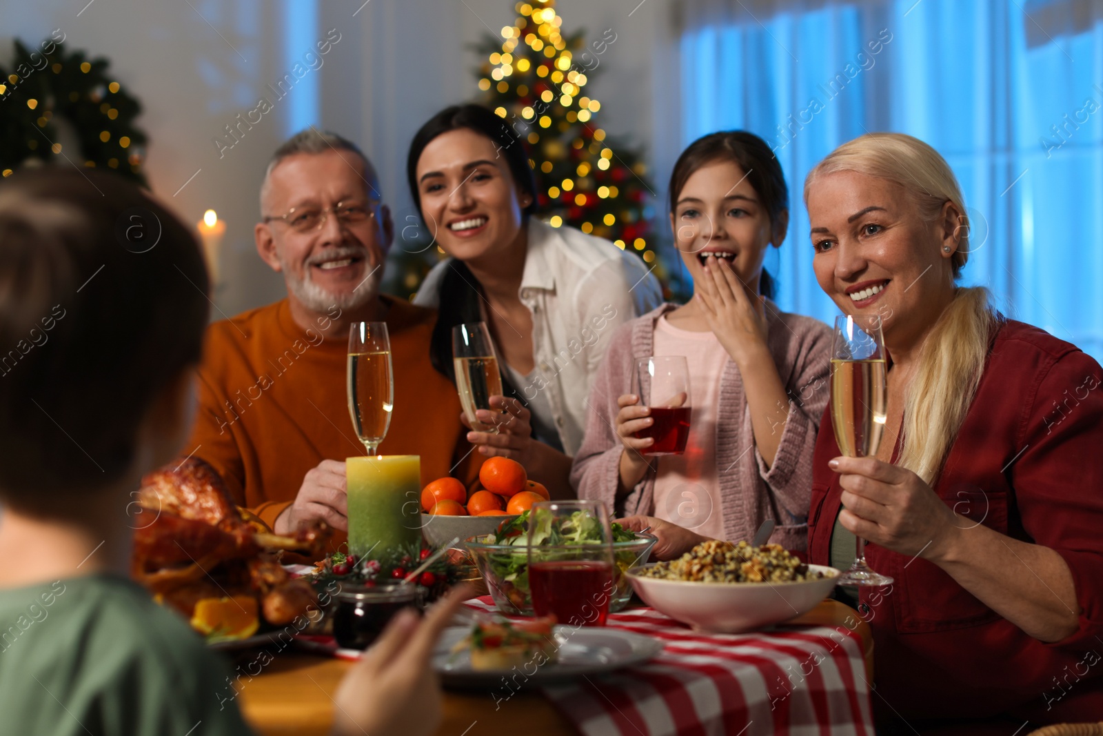 Photo of Happy family enjoying festive dinner at home. Christmas celebration