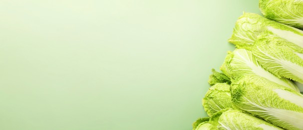 Image of Fresh ripe Chinese cabbages on green background, top view. Banner design with space for text