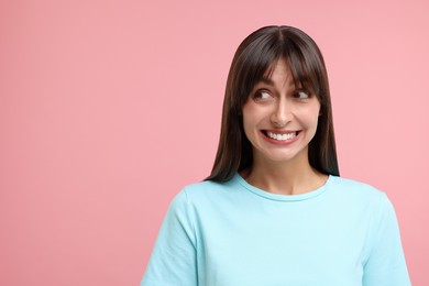Photo of Embarrassed woman on pink background, space for text