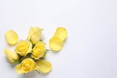 Photo of Beautiful yellow roses and petals on white background, flat lay. Space for text