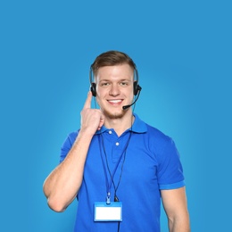 Photo of Portrait of technical support operator with headset on color background
