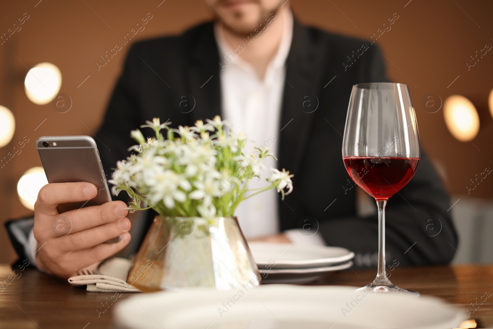 Photo of Man with glass of wine at table in restaurant