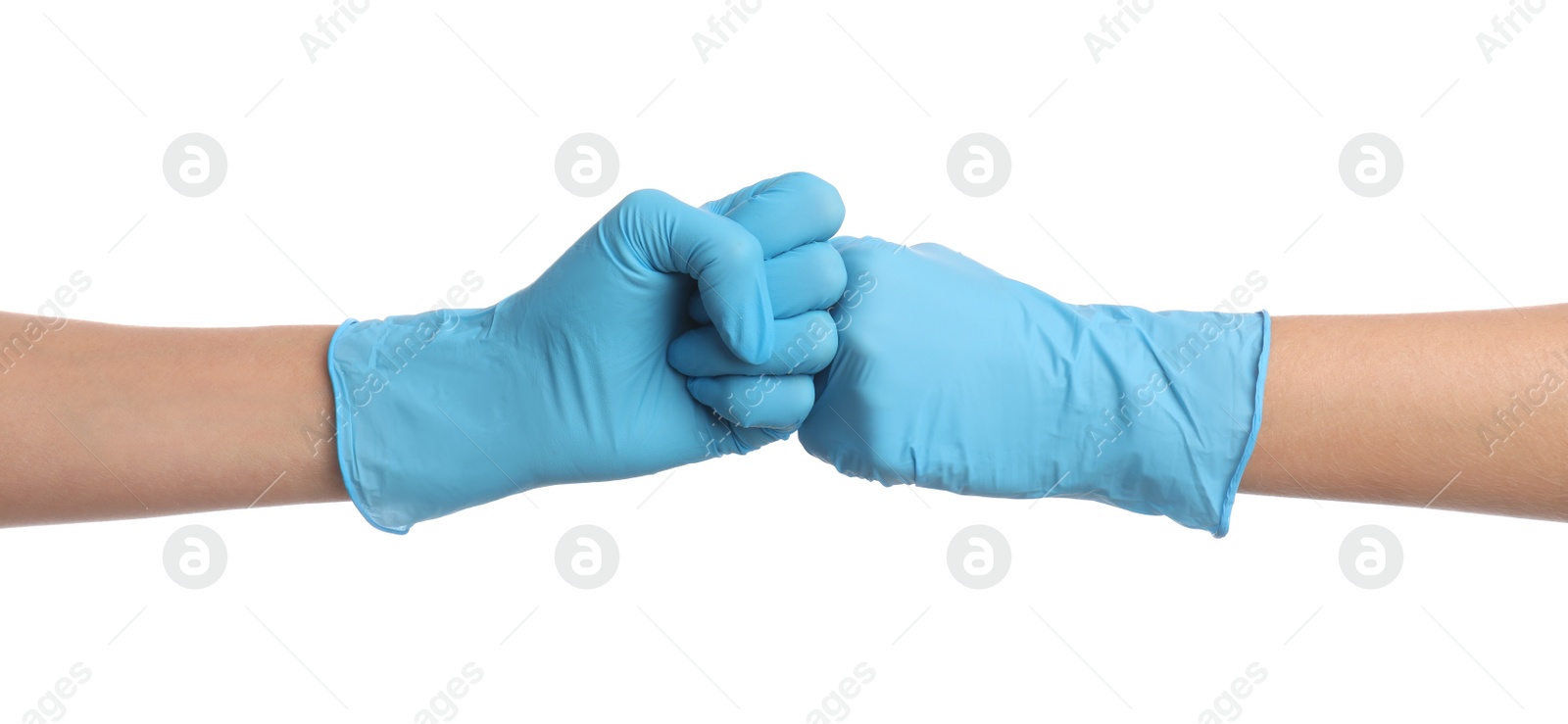 Photo of Doctors in medical gloves making fist bump on white background, closeup