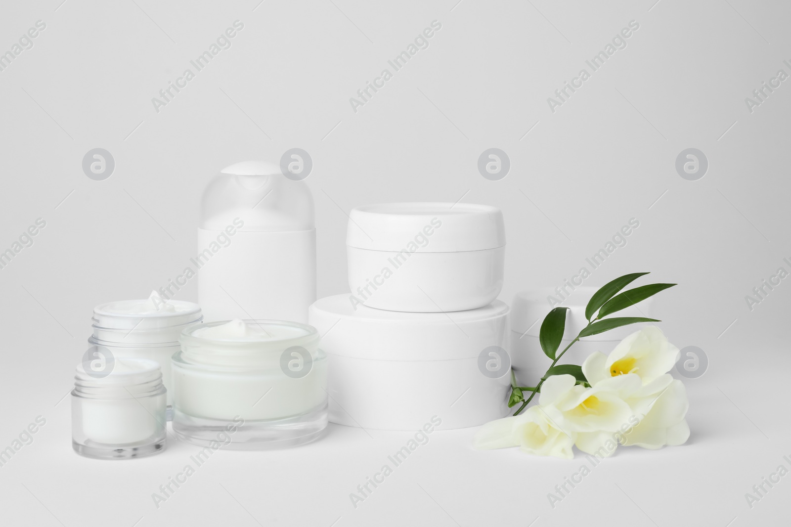 Photo of Composition with cosmetic products on light background