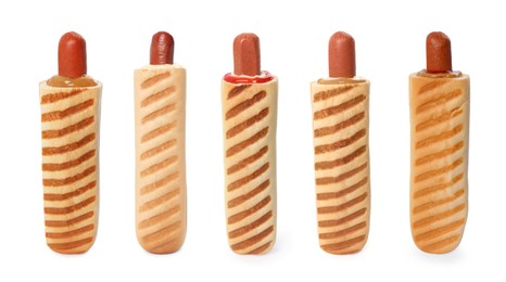 Image of Set of yummy French hot dogs with grilled buns and different sauces isolated on white