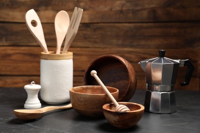 Set of different kitchen utensils on grey table