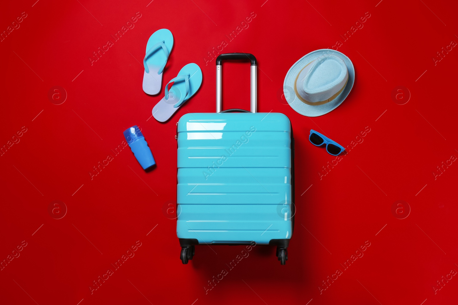 Photo of Flat lay composition with stylish suitcase and accessories on color background