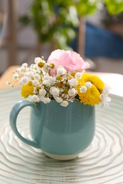 Photo of Beautiful bright flowers in light blue cup