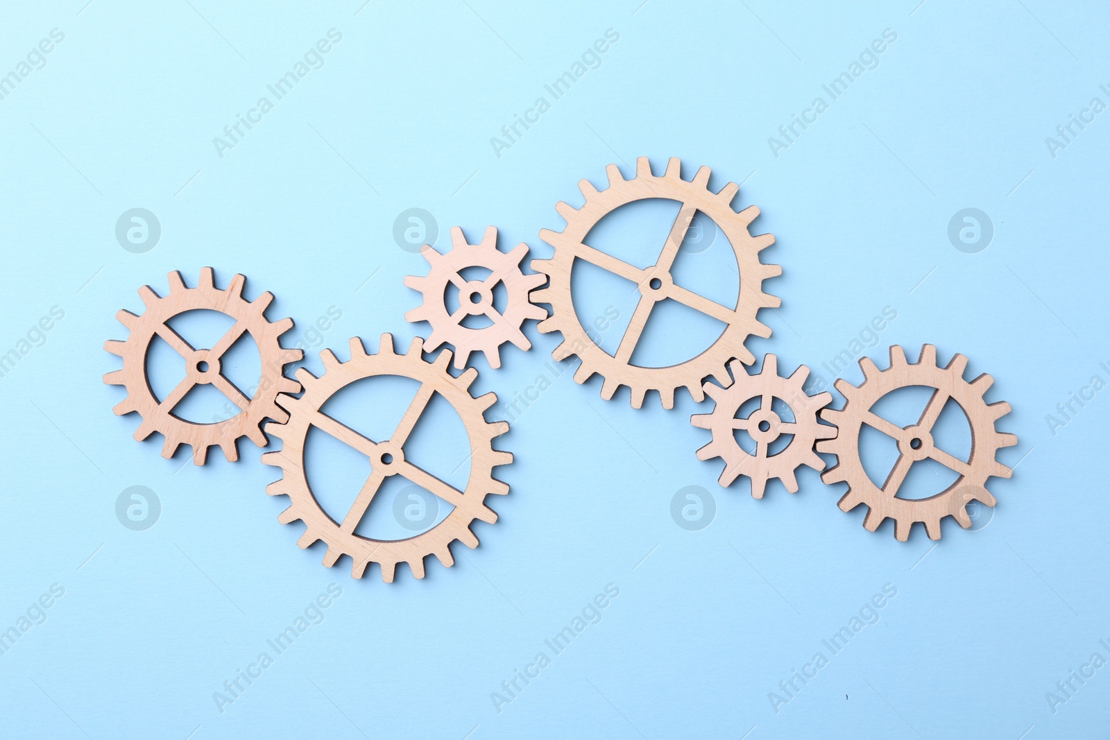 Photo of Business process organization and optimization. Scheme with wooden figures on light blue background, top view