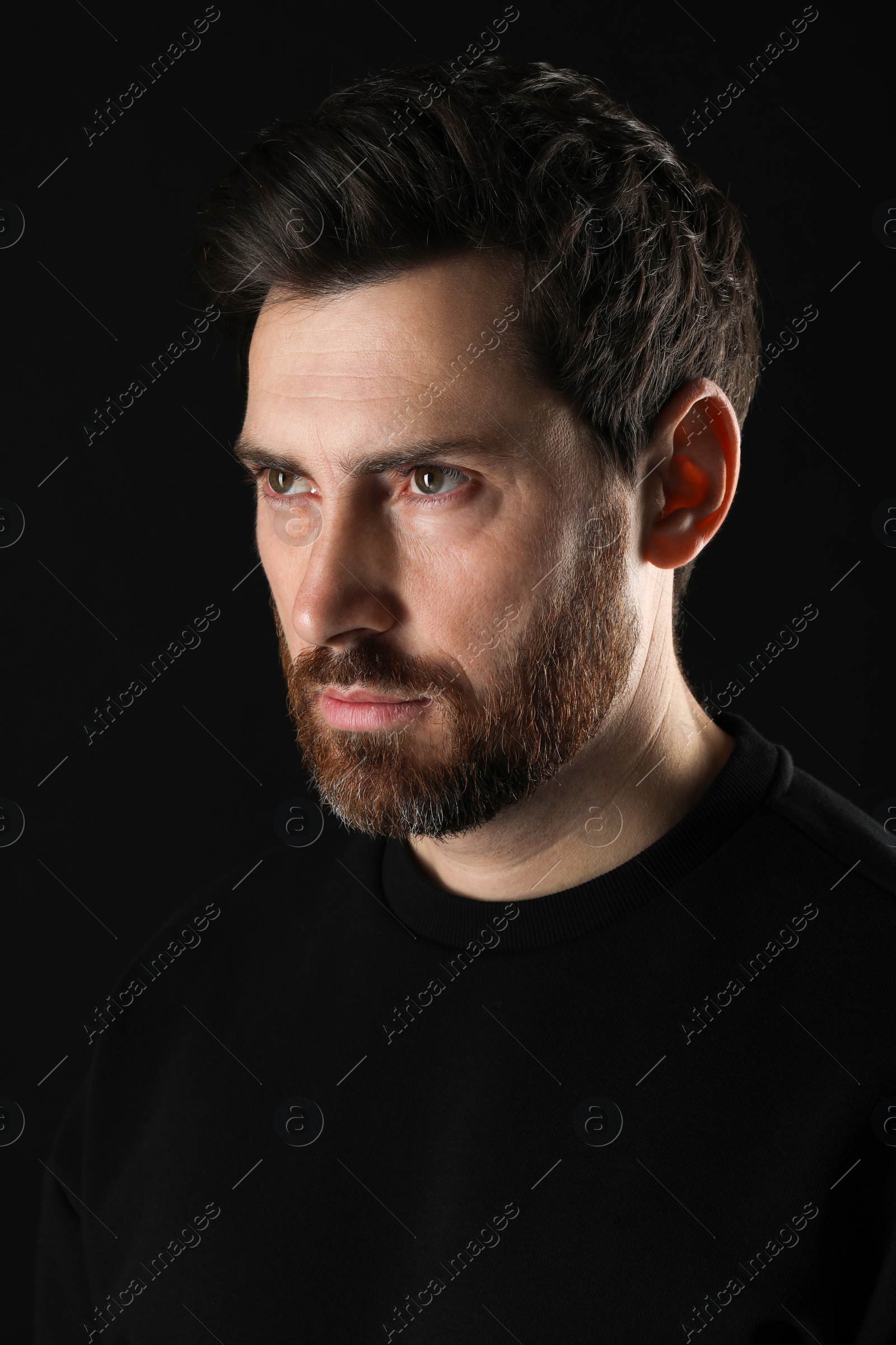 Photo of Evil eye. Man with scary eyes on black background