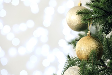 Beautiful decorated Christmas tree against blurred lights, closeup with space for text. Bokeh effect