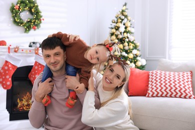Happy family in room decorated for Christmas