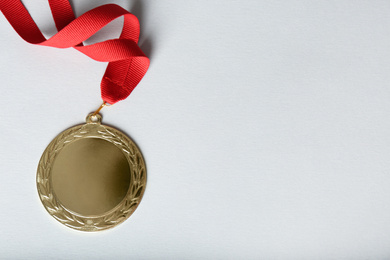 Gold medal on white background, top view. Space for design