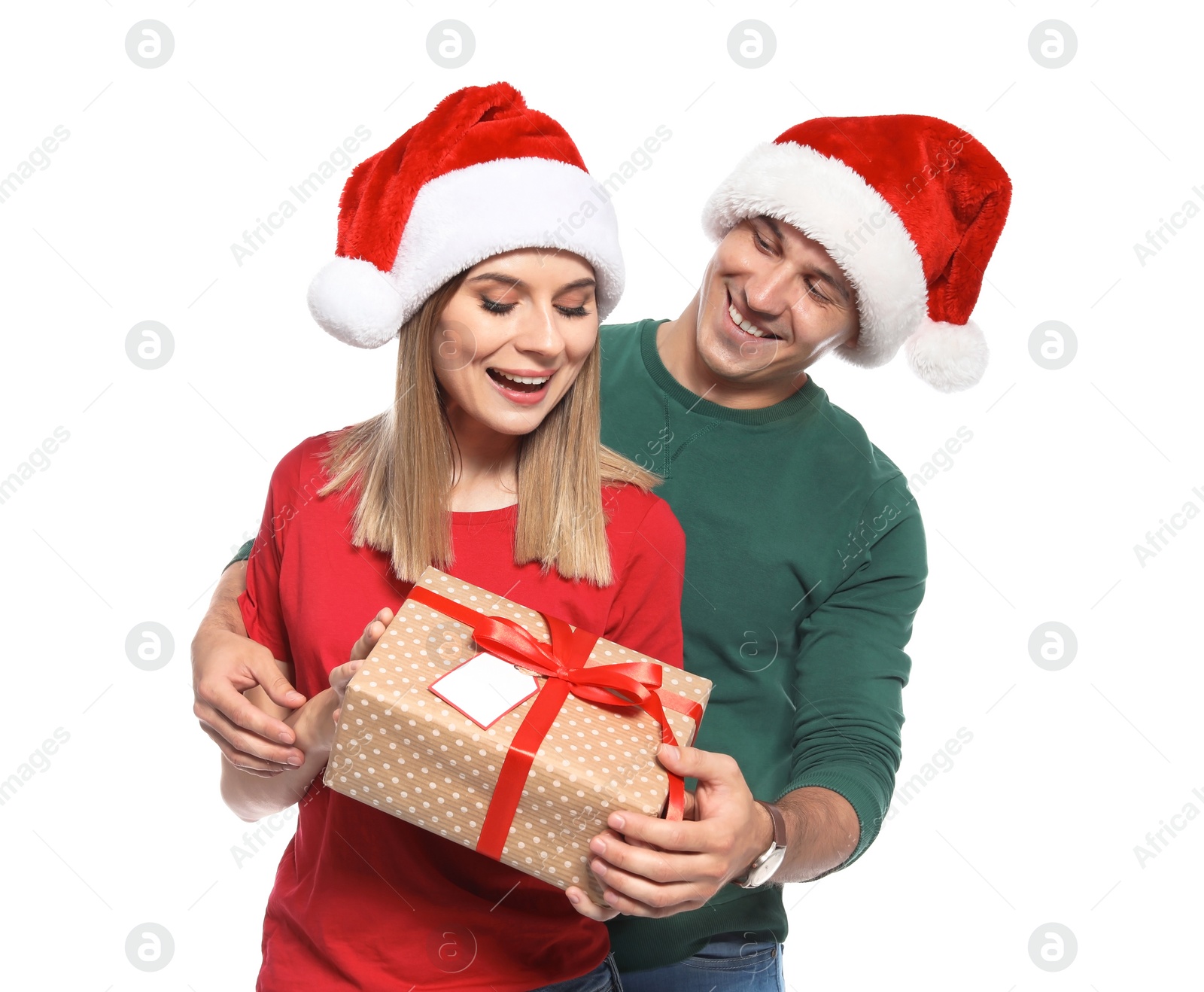 Photo of Young couple with Christmas gift on white background