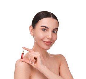 Beautiful young woman holding skincare ampoule on white background