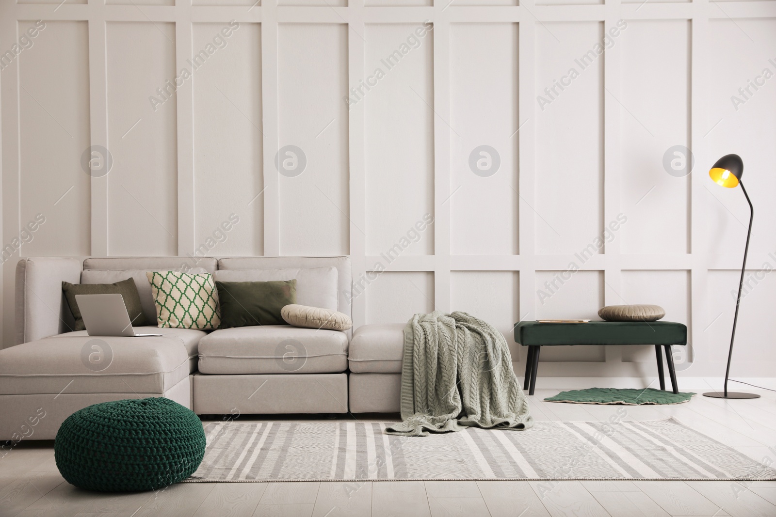 Photo of Living room with comfortable grey sofa and stylish interior elements