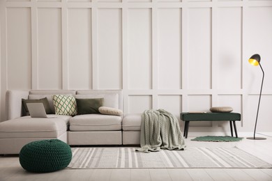 Photo of Living room with comfortable grey sofa and stylish interior elements