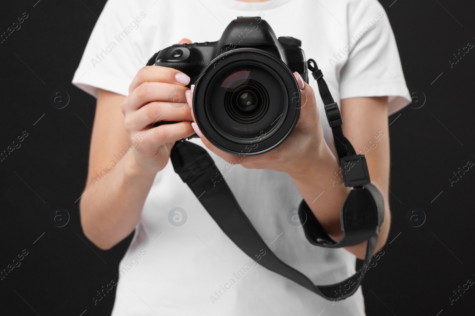 Photo of Photographer with camera on black background, closeup