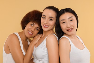 Photo of Portrait of beautiful young women on beige background