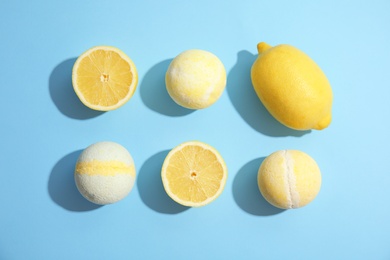 Flat lay composition with bath bombs and lemons on color background