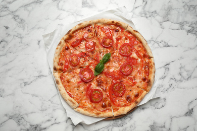 Delicious pizza Margherita on white marble table, top view