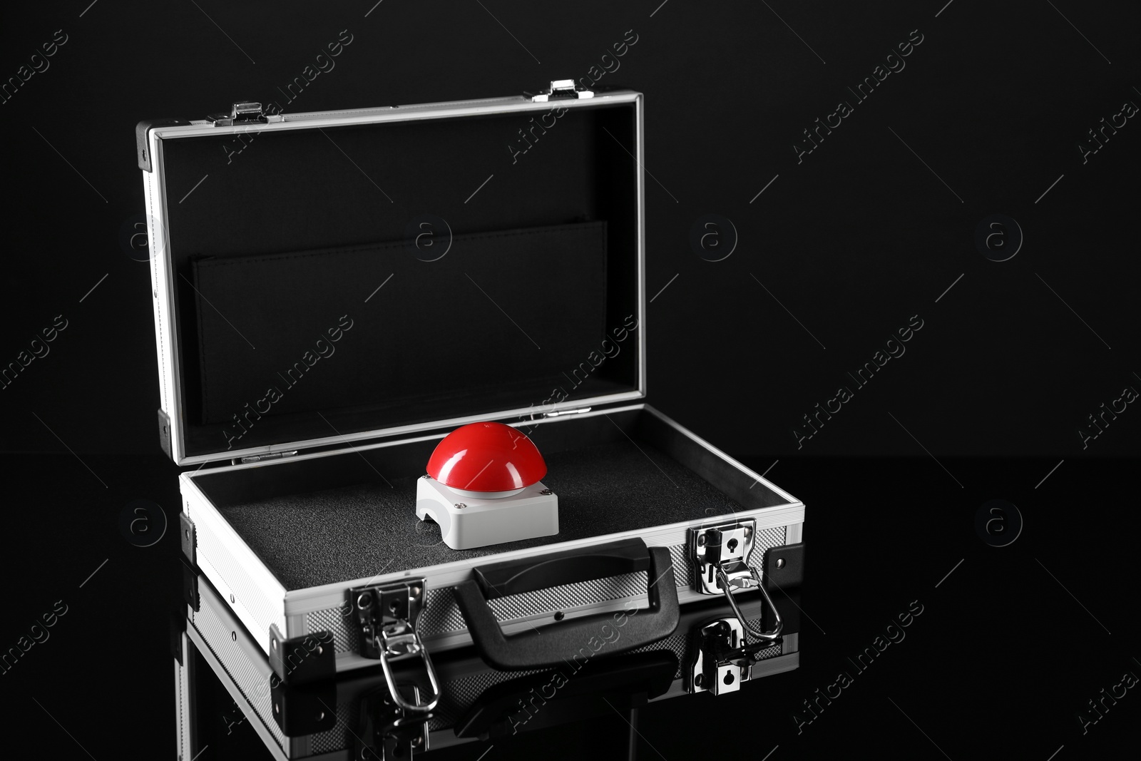 Photo of Red button of nuclear weapon in suitcase on black background, space for text. War concept