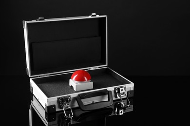 Photo of Red button of nuclear weapon in suitcase on black background, space for text. War concept