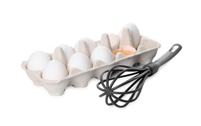 Photo of Whisk and carton with raw eggs isolated on white