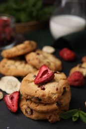 Photo of Cookies with freeze dried fruits and mint on grey table, closeup