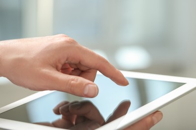 Closeup view of man using new tablet indoors