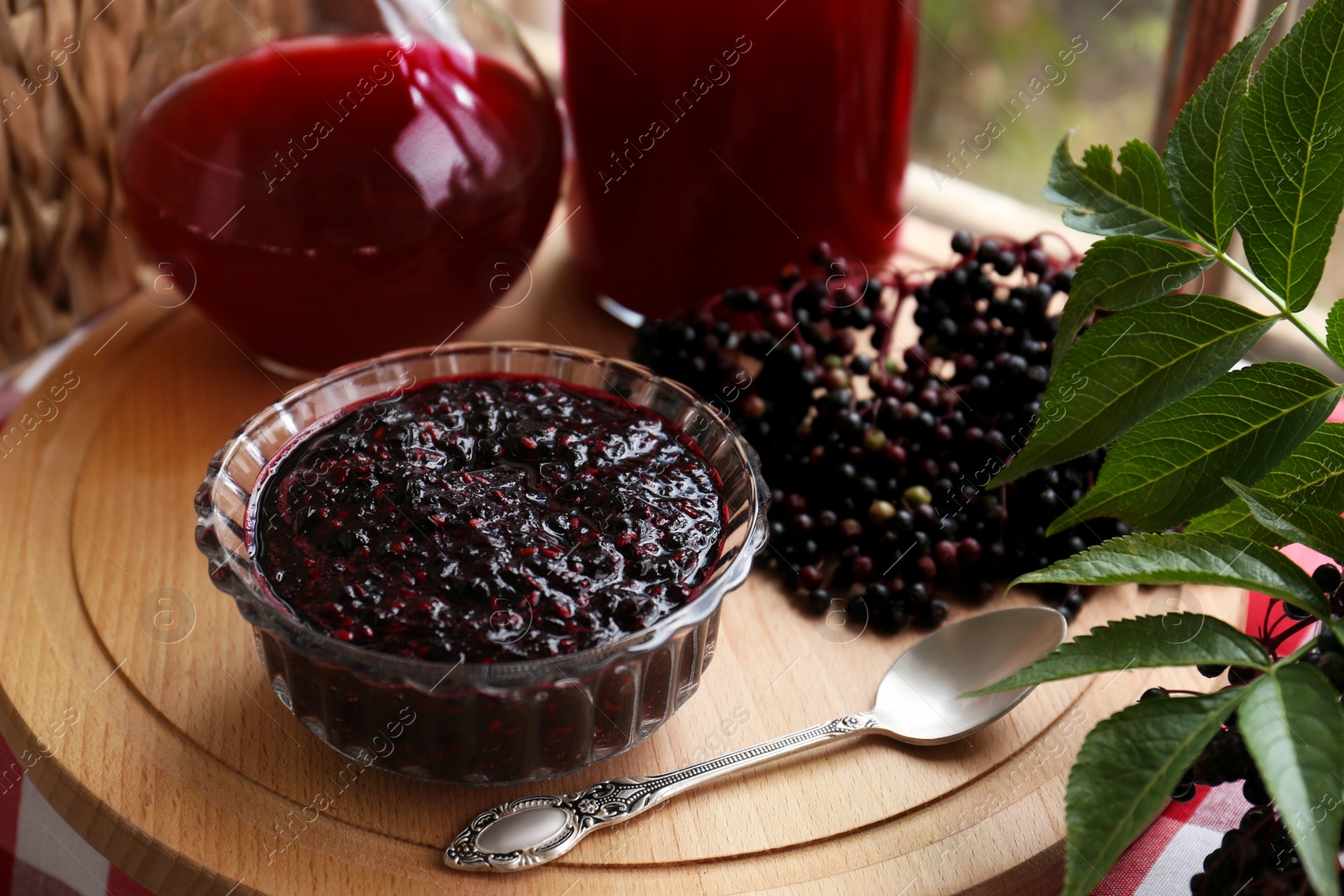 Photo of Elderberry jam and drink with Sambucus berries on table, closeup