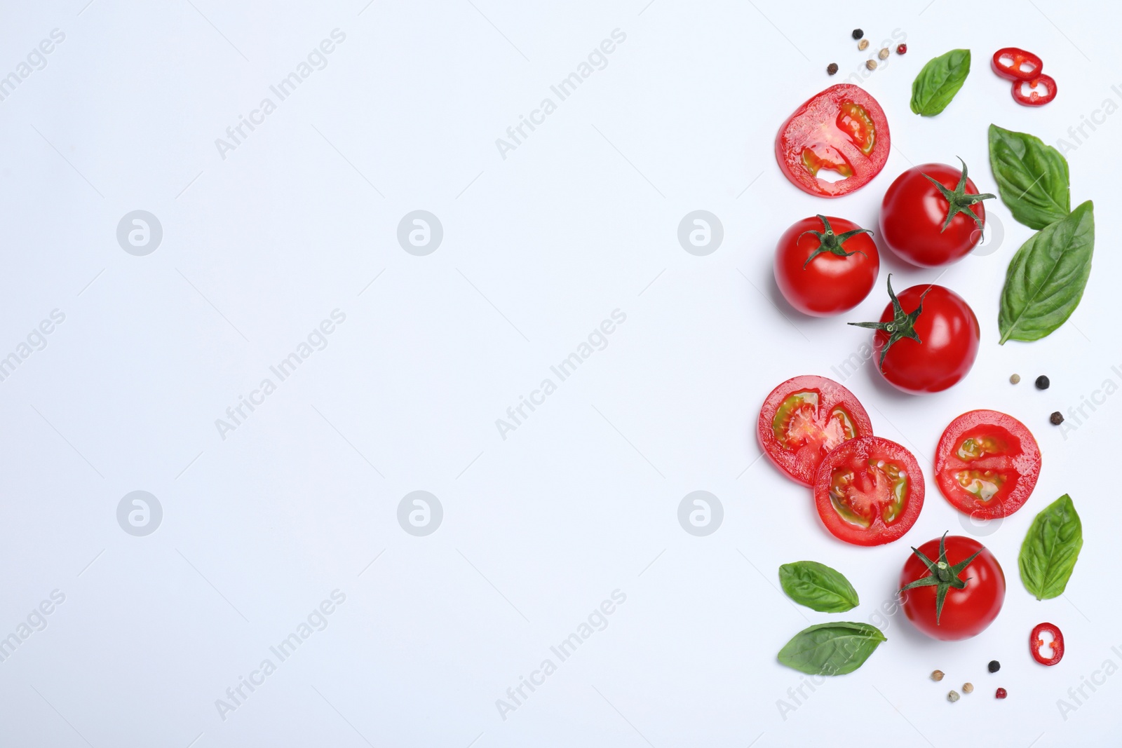 Photo of Composition with fresh basil leaves and tomatoes on white background, flat lay. Space for text