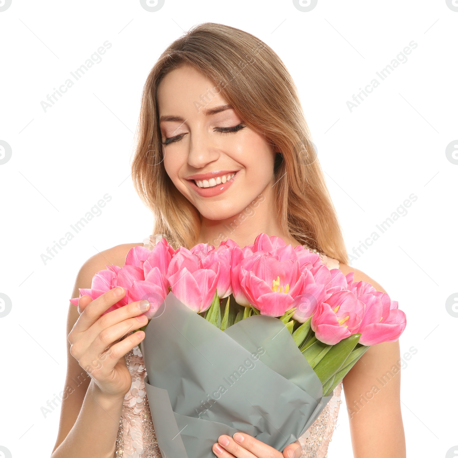 Photo of Portrait of smiling young girl with beautiful tulips on white background. International Women's Day